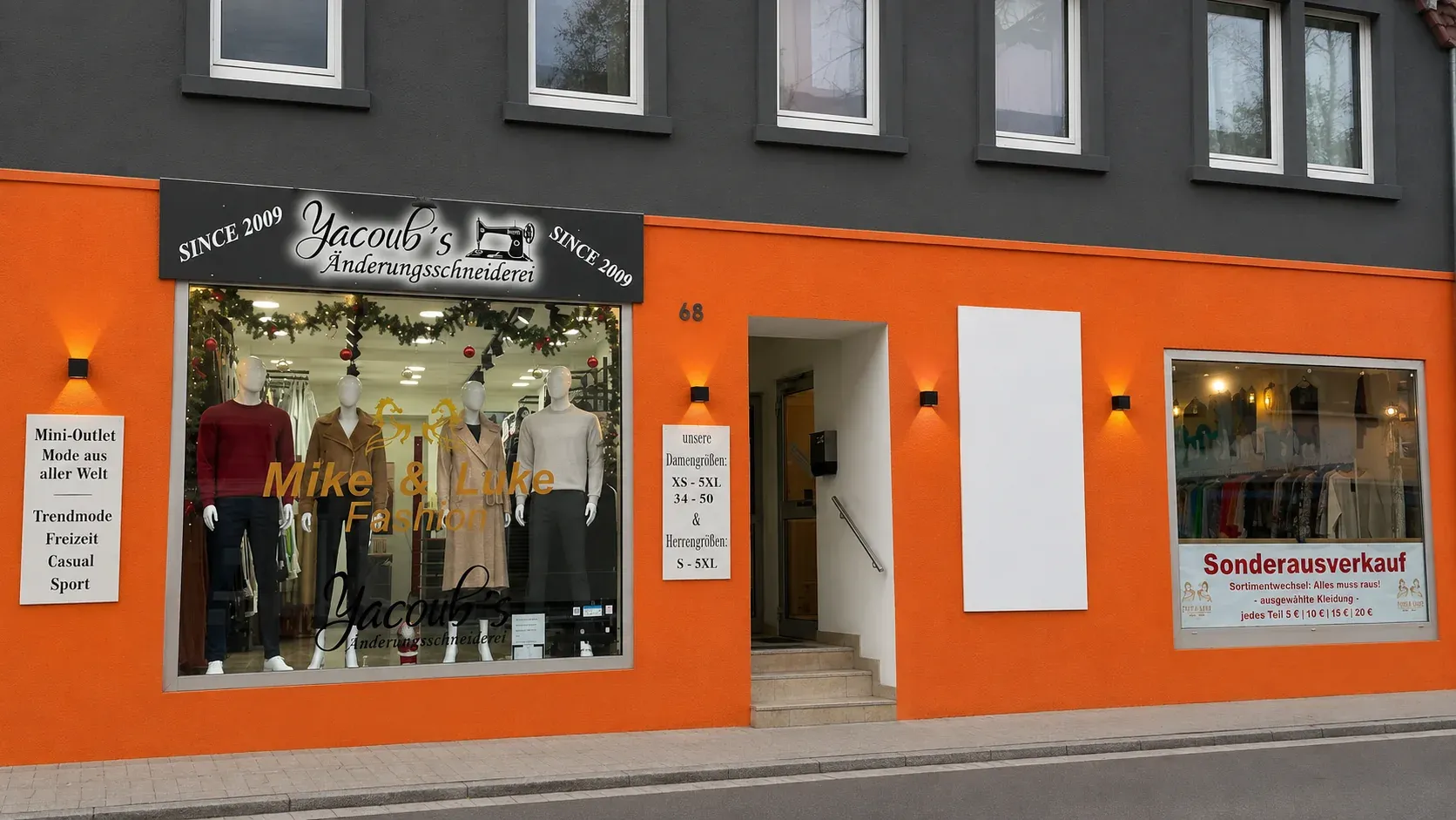 Die Hauptstraße 68 in Nußloch. Der Ladenbereich ist orange gestrichen, darüber ein schwarzes Schild mit dem Schriftzug „Yacoub’s Änderungsschneiderei“, einer Nähmaschine als Zeichen und der Angabe „SINCE 2009“ auf beiden Seiten. Im Schaufenster stehen Schaufensterpuppen mit Kleidung, daneben der Schriftzug des Bekleidungsladens „Mike & Luke Fashion", der im selben Haus liegt.
